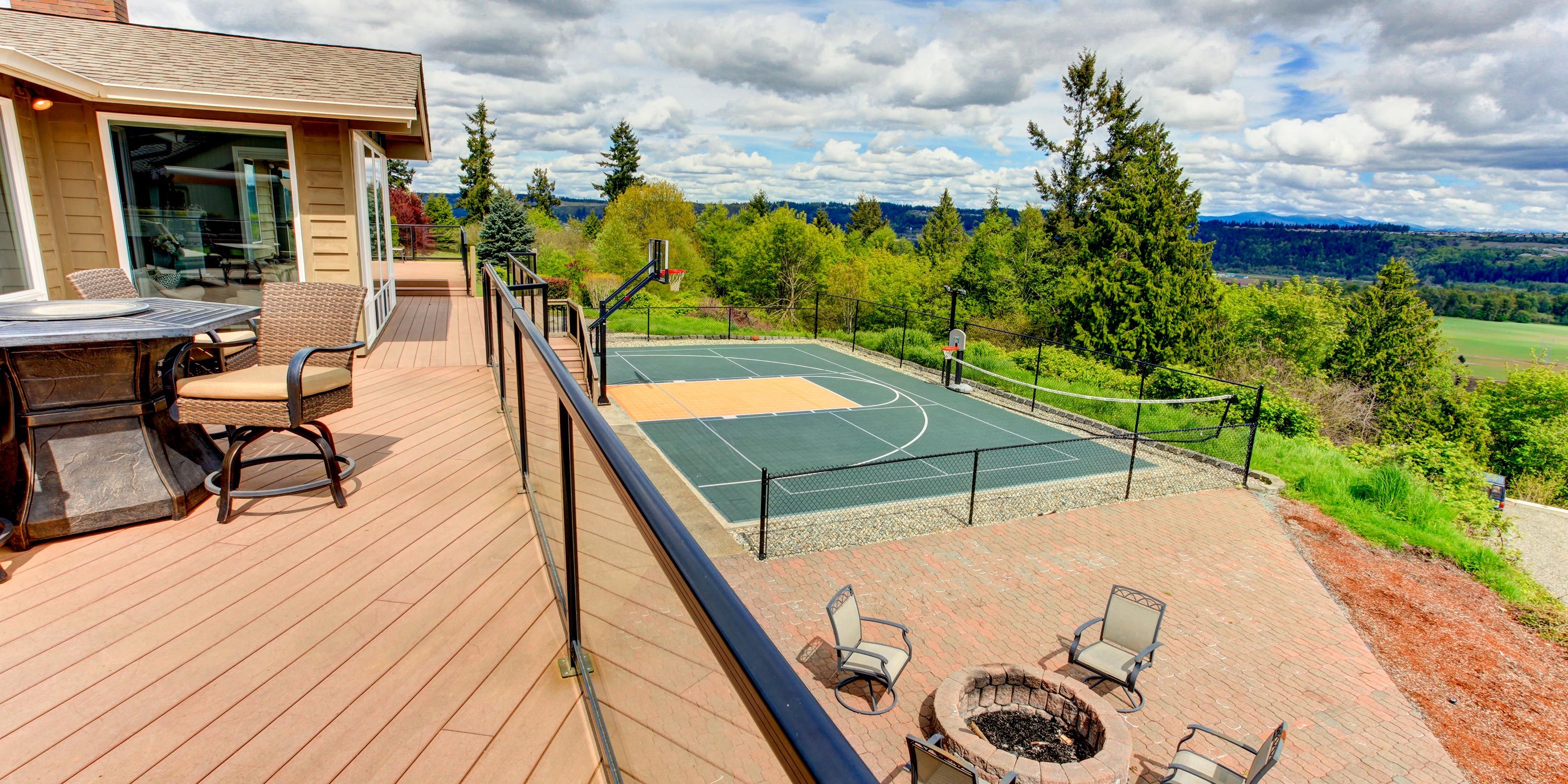 Elevated deck overlooking a basketball court and scenic landscape.