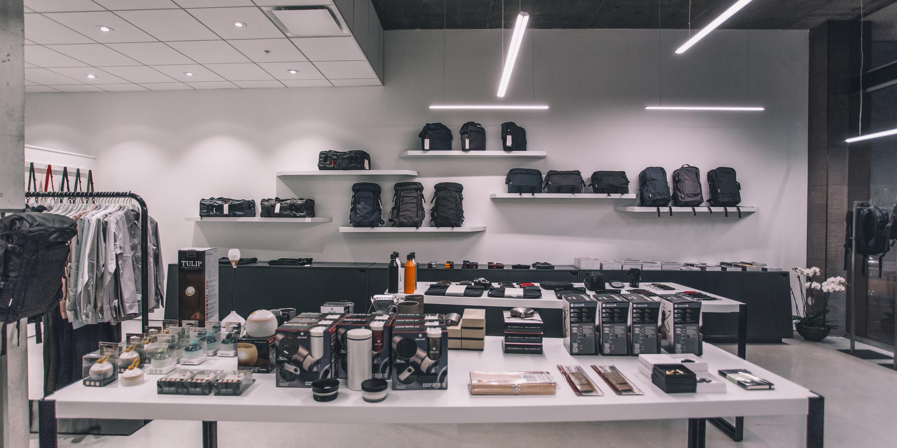 Sleek retail store with minimalist shelves, neatly displayed products, and modern lighting.